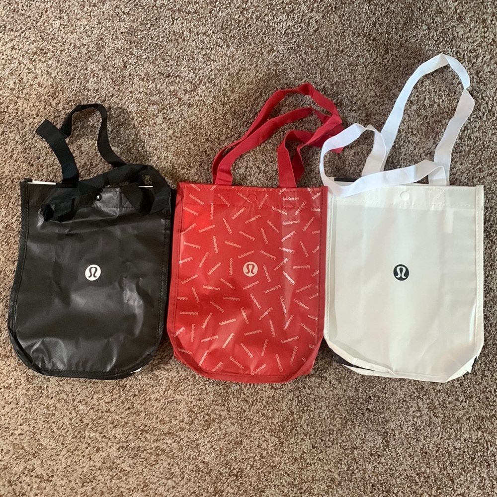 Set of 3 Lululemon shopping bags.